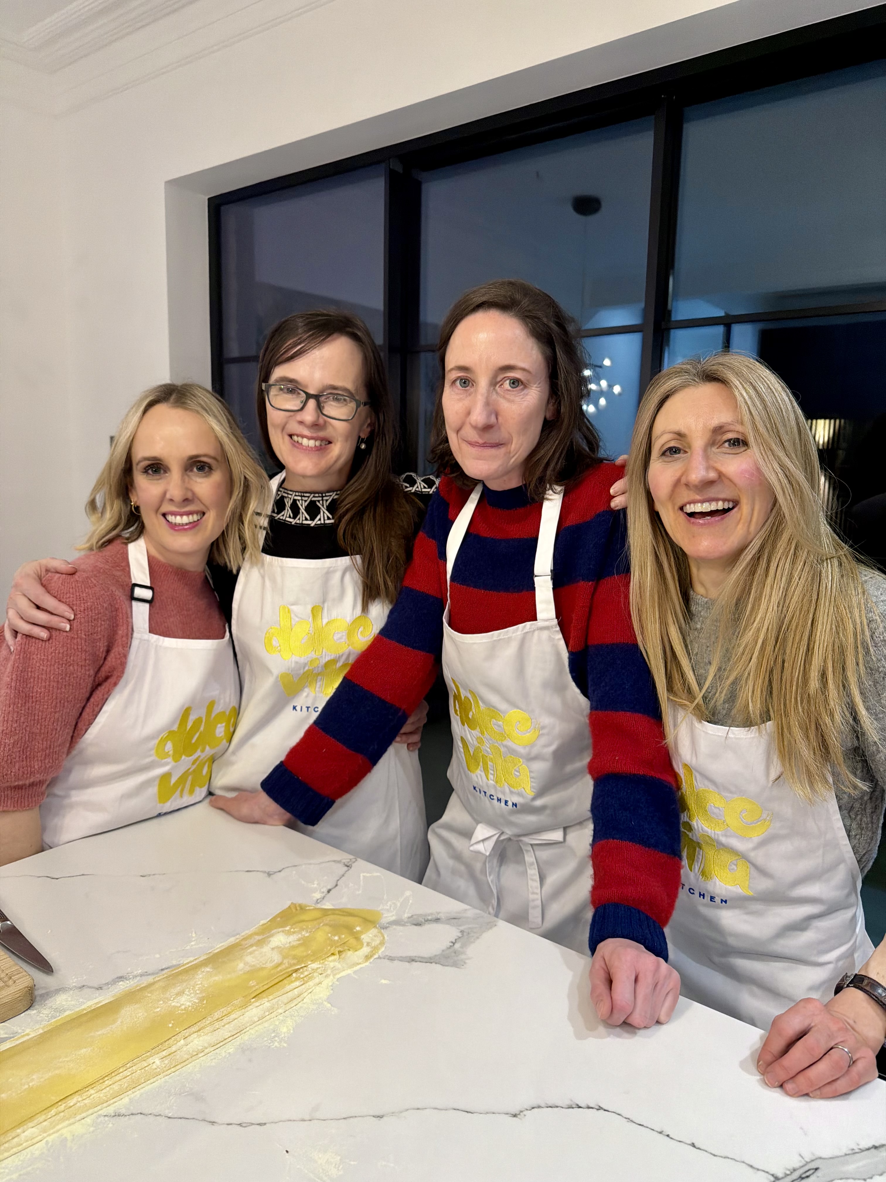 Guests making fresh pasta together, evening class