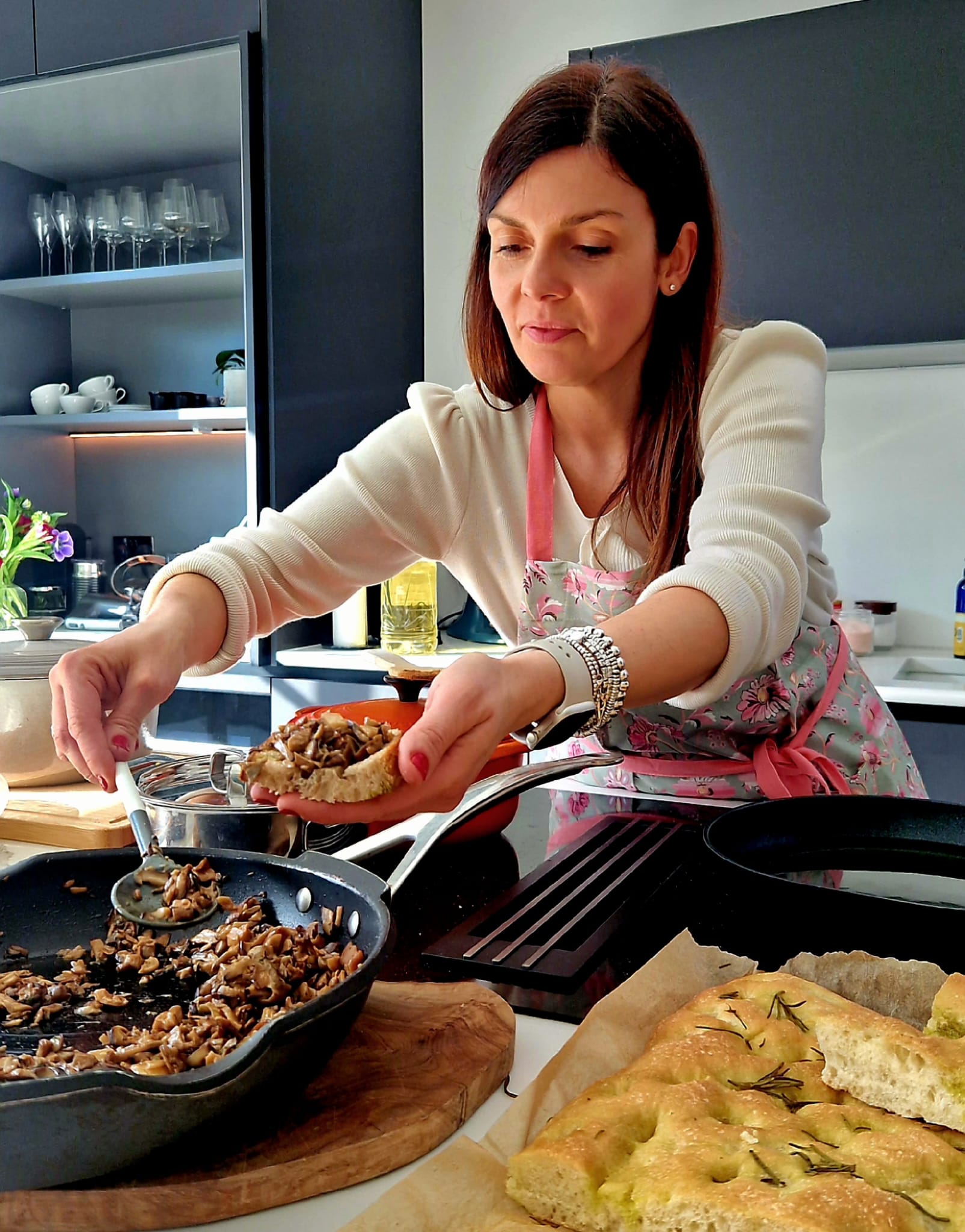 Ilaria plating focaccia in her kitchen